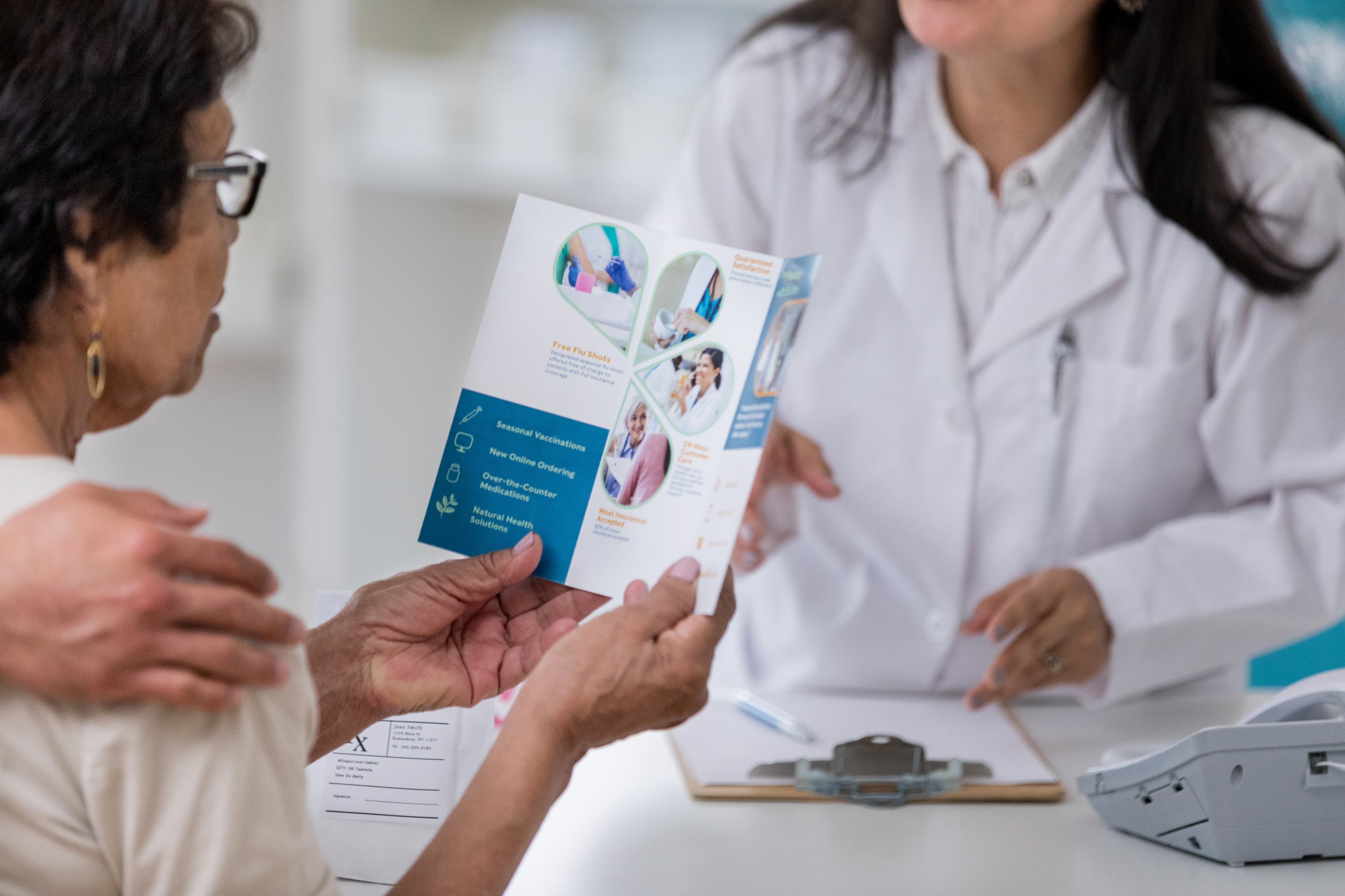 A patient in a healthcare setting reading a medical brochure.