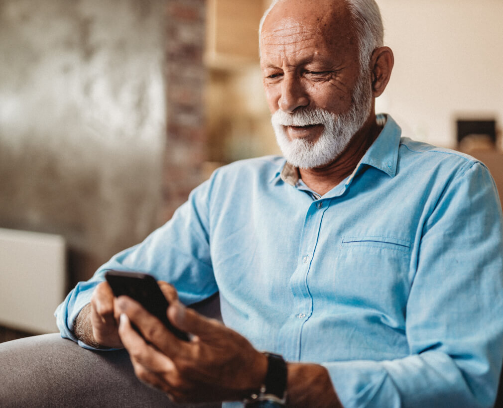 Senior man ordering meals on a phone.