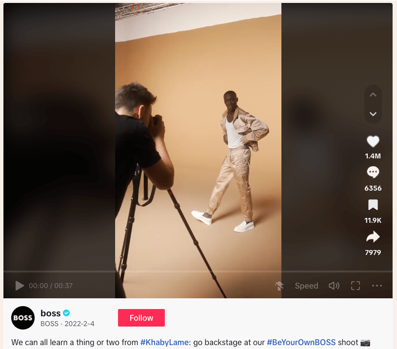 Photographer taking photo of model in white outfit during fashion photoshoot