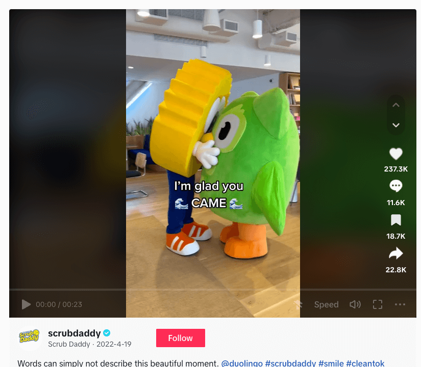 Two cartoon cleaning mascots hugging in an indoor setting