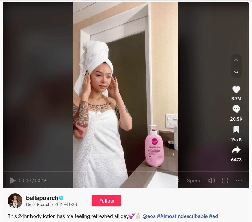 Person in white towel with body lotion, showing skincare routine