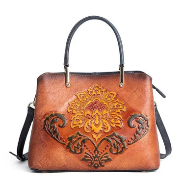 Leather handbag with ornate yellow and brown floral tooled design