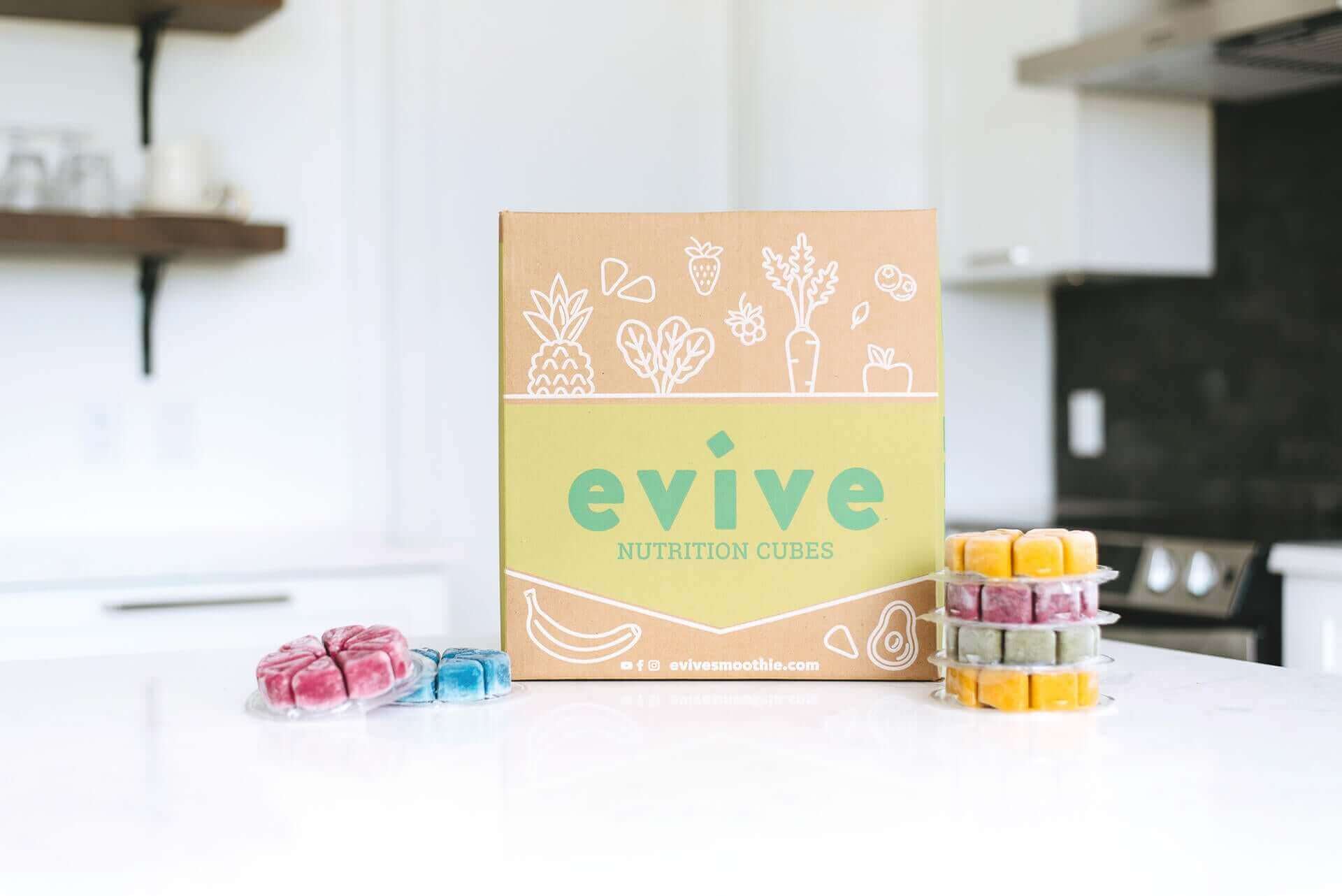 Evive Nutrition Cubes box with colorful frozen smoothie cubes in kitchen