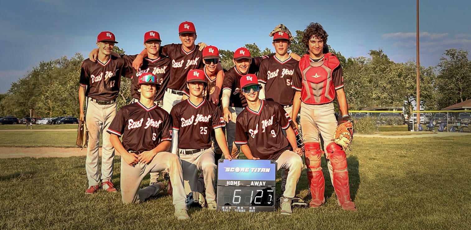 East York baseball team posing together with scoreboard after game