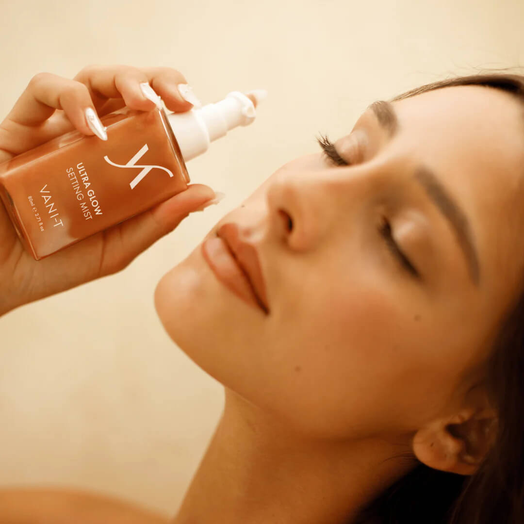 Skincare model applying Ultra Glow Setting Mist with closed eyes