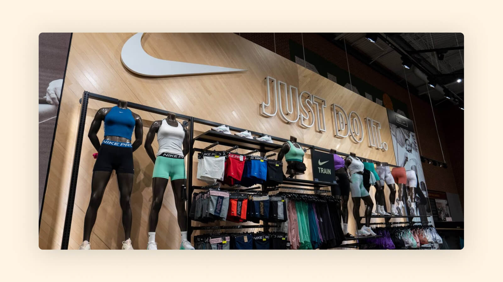 Nike store display with athletic wear, mannequins, and "Just Do It" sign