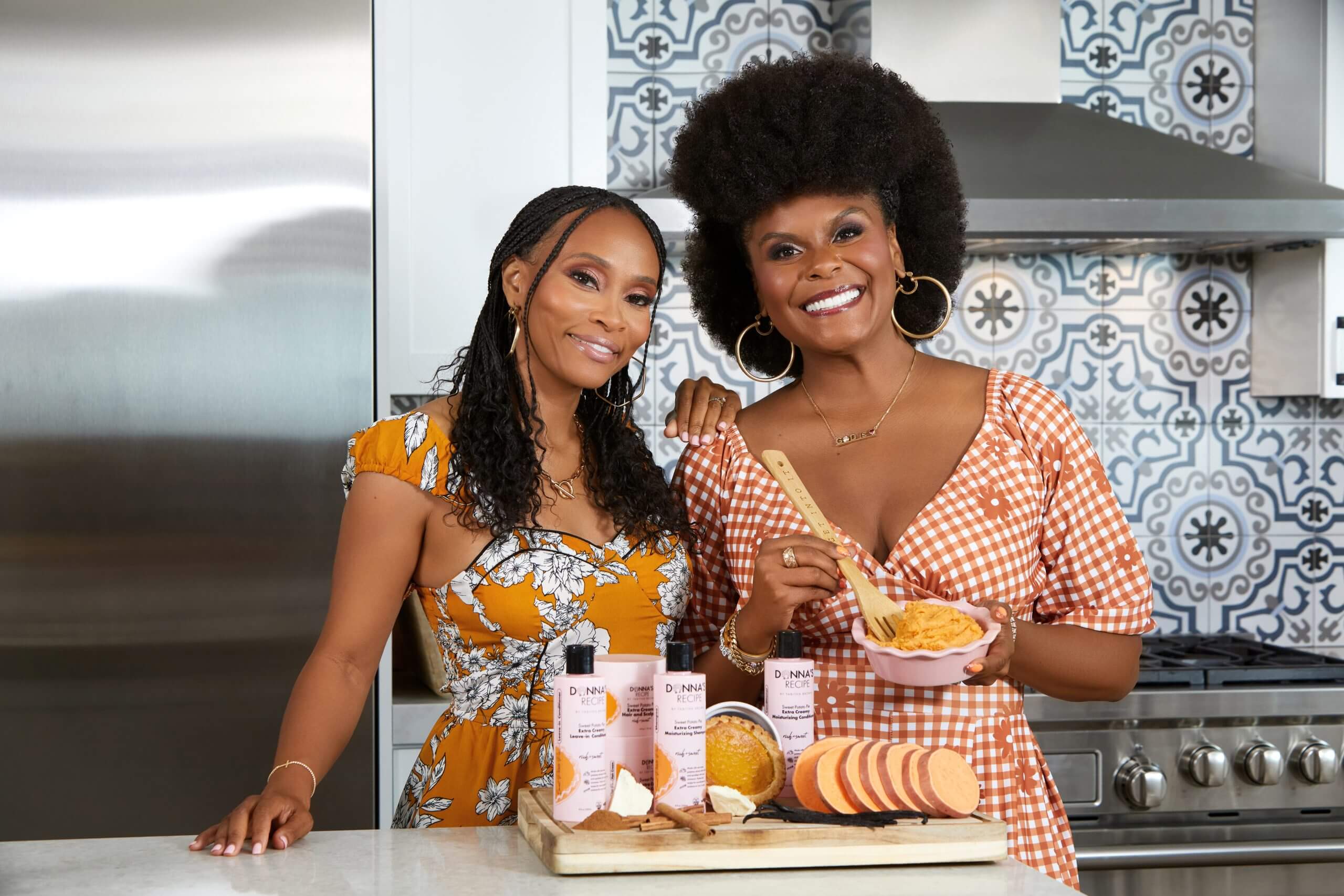 Two women in kitchen with skincare products and baked goods