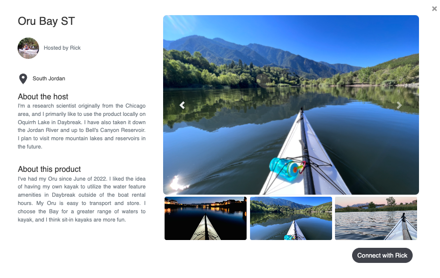 Kayak on calm lake with mountain reflection and blue sky