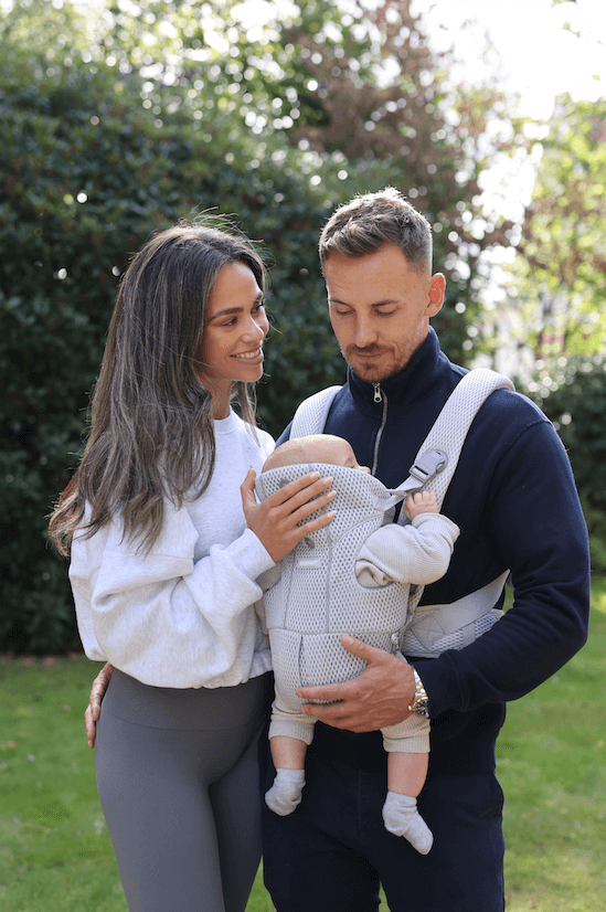 Parents using a BabyGo carrier