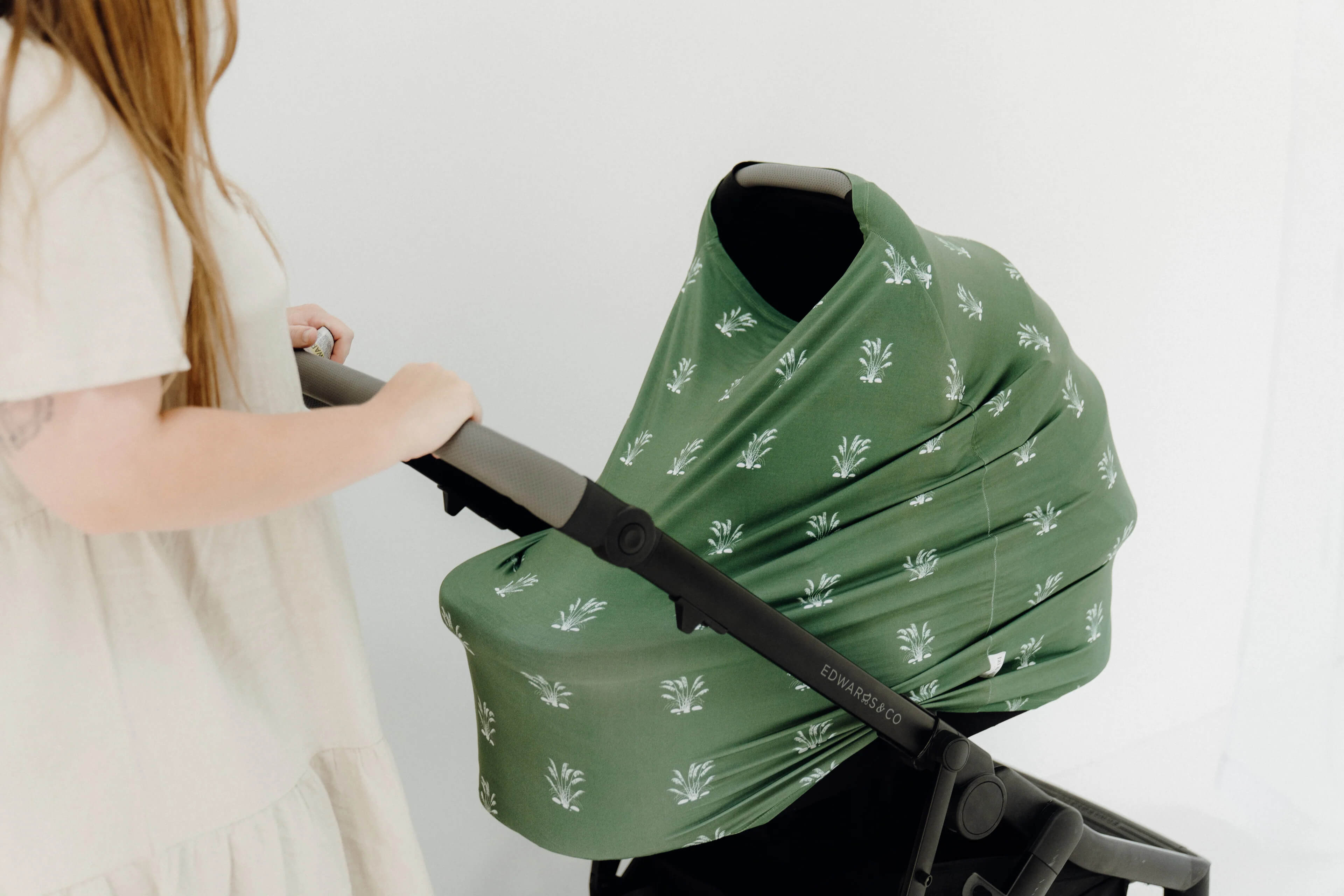 A women pushing her stroller with a Izi & Al wrapper around it