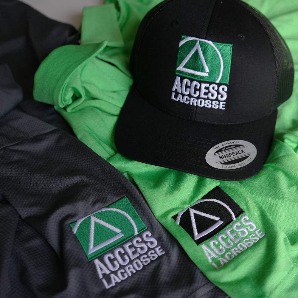 Black snapback hat and green and black shirts with Access Lacrosse embroidered logos.