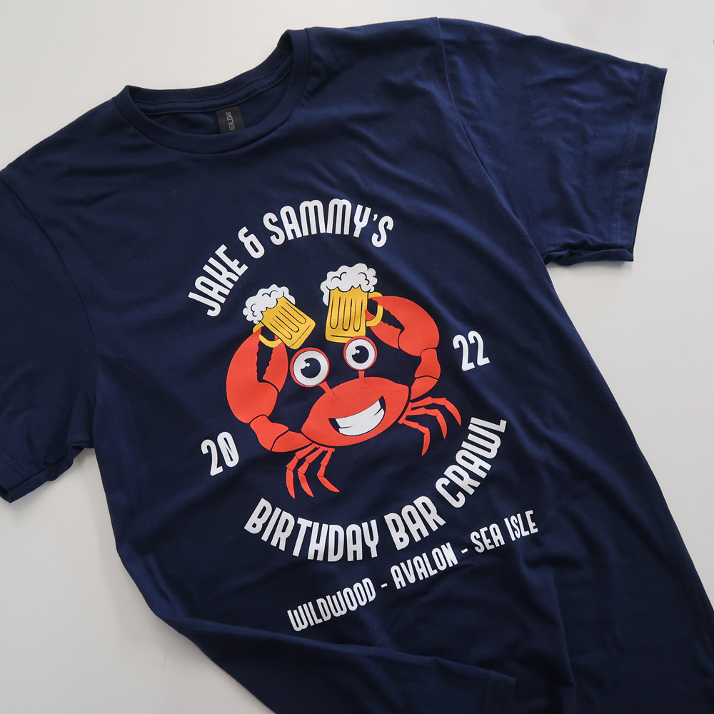 Navy blue t-shirt with a cartoon crab holding two beer mugs 