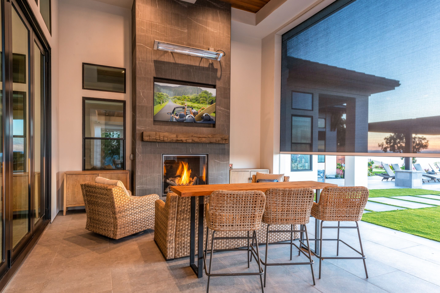Outdoor patio with wicker furniture, fireplace, TV, and large exterior shades in Santa Rosa, California.