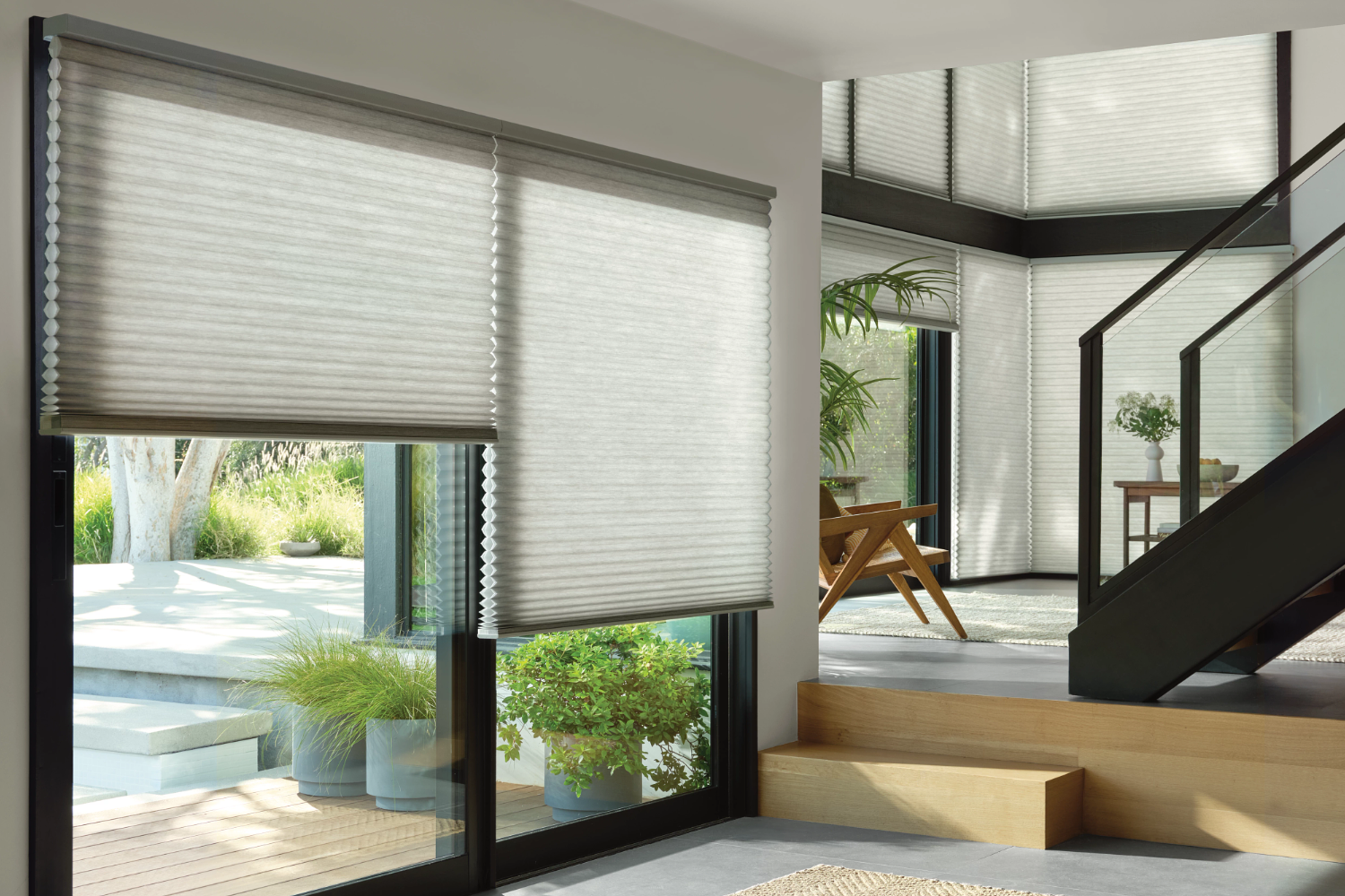 Modern window blinds in a sunlit room.