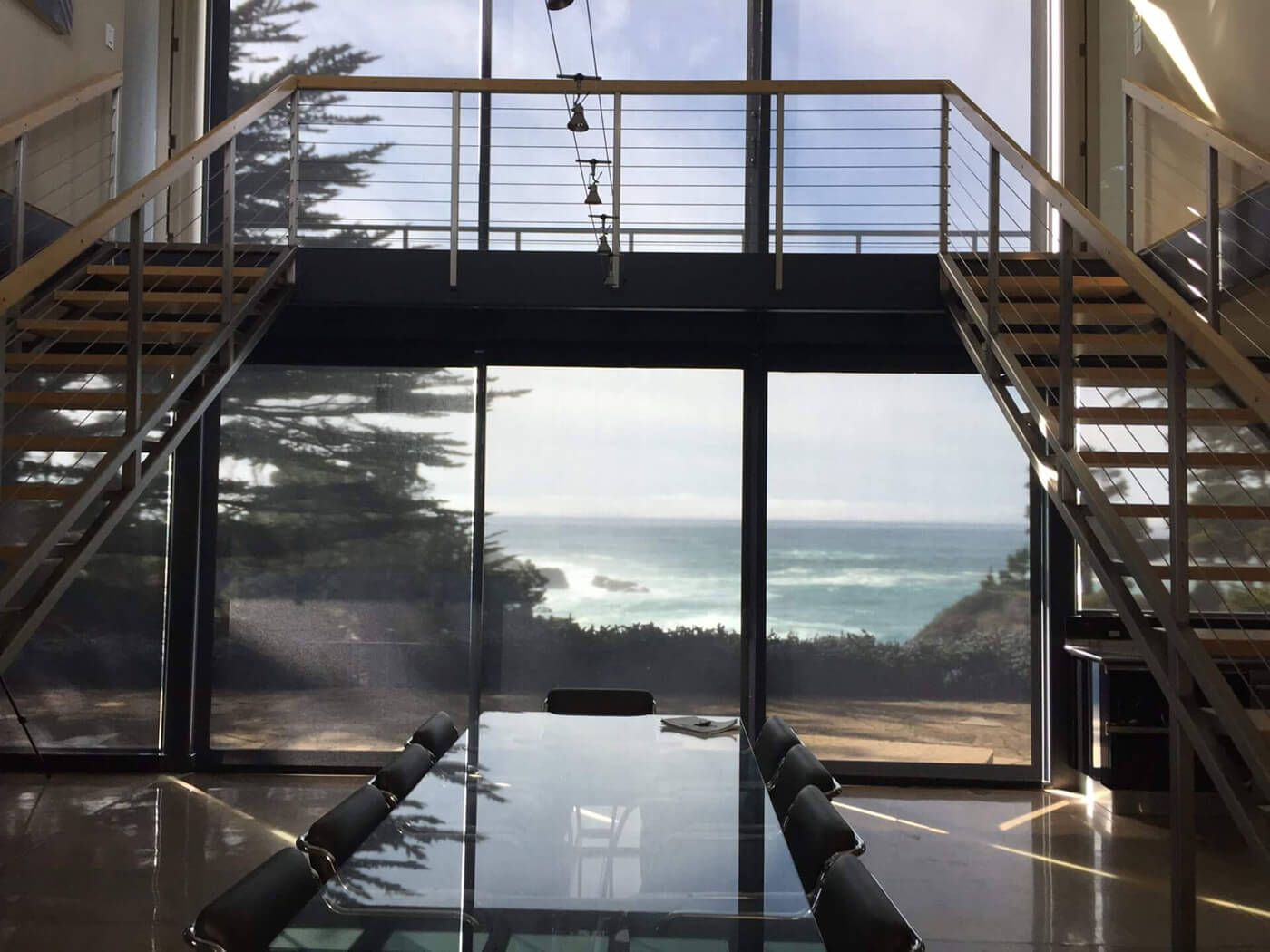 Modern dining room, ocean view, solar shades.