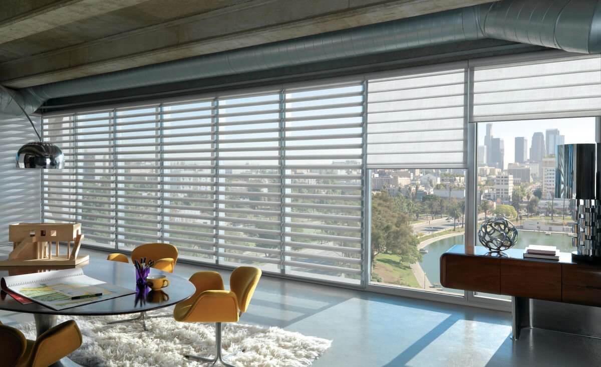 Modern room with light-filtering shades and city view.