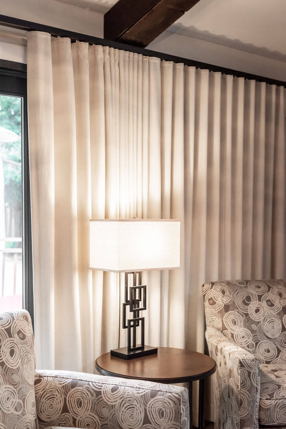 Modern interior with beige drapes and patterned chairs in Santa Rosa, California.