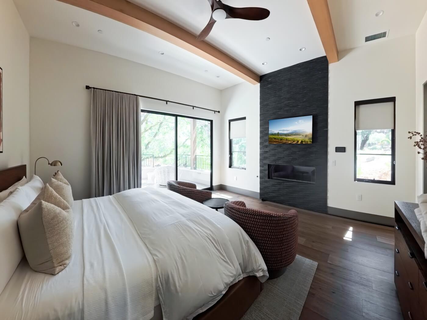 Modern bedroom with drapes and side panels.