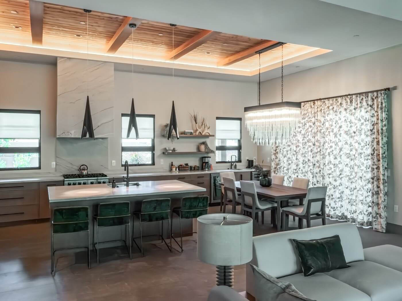 Modern kitchen with floral drapes and side panels.