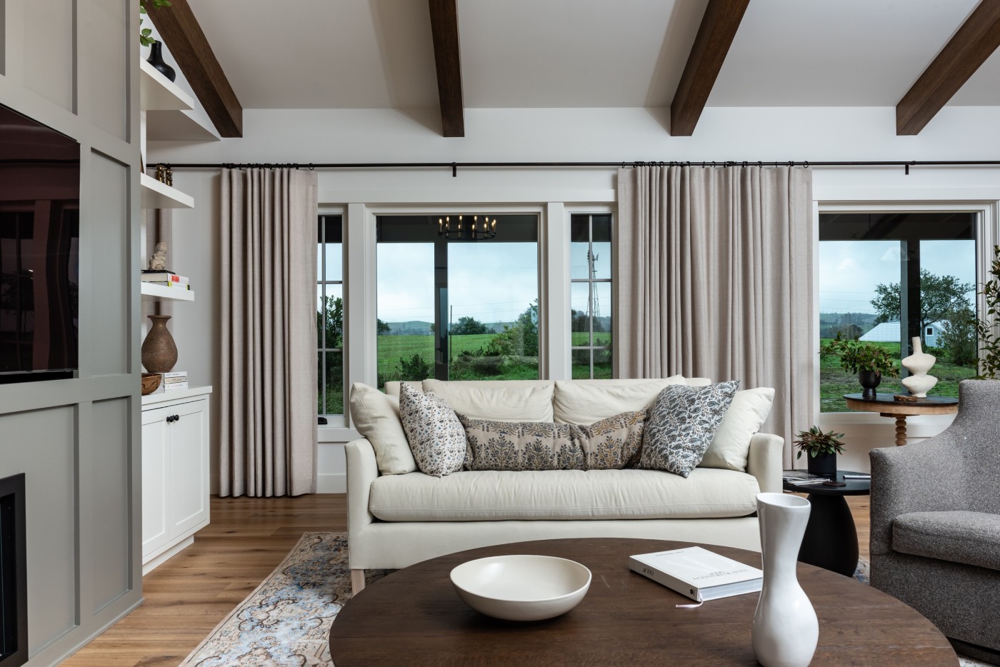 Living room with beige drapes behind a cream sofa, Santa Rosa.