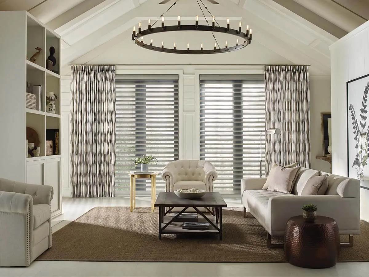 Elegant living room with patterned drapes, side panels, and large windows.