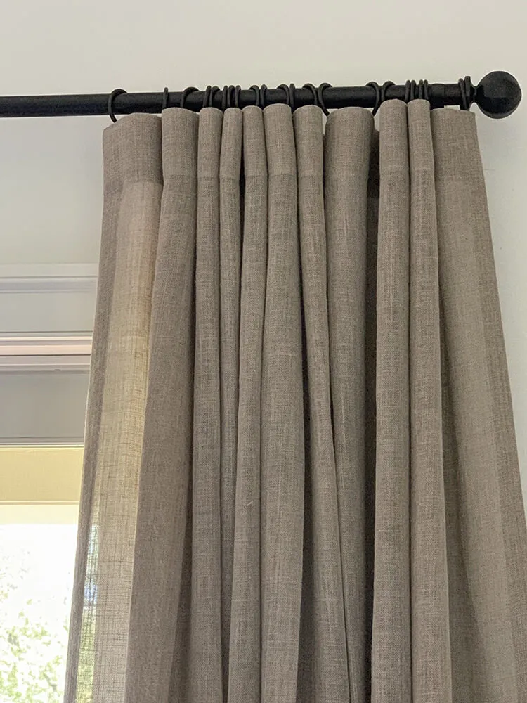 Beige drapes on black rod