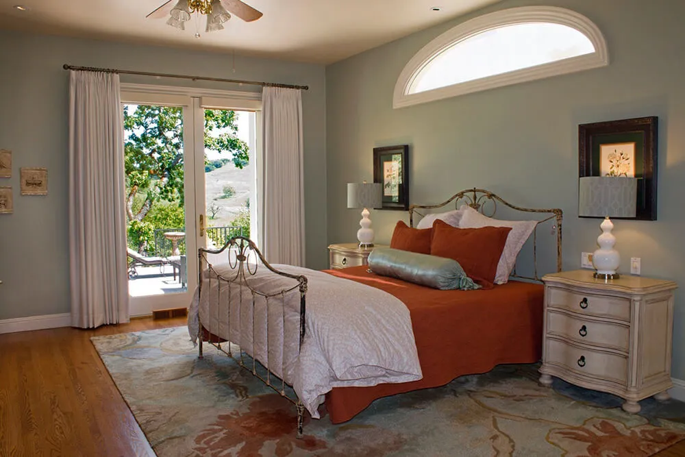 Elegant bedroom with drapes and side panels on French doors, Santa Rosa.
