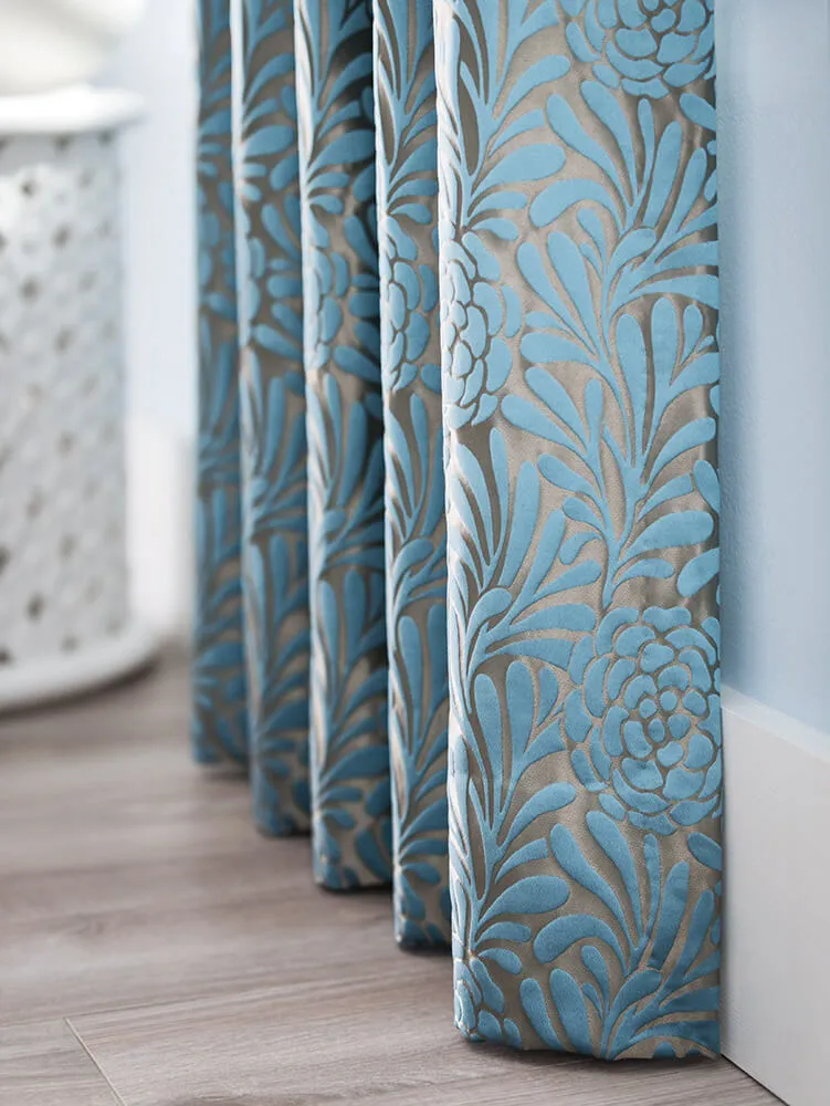 Blue floral-patterned drapes in a room.