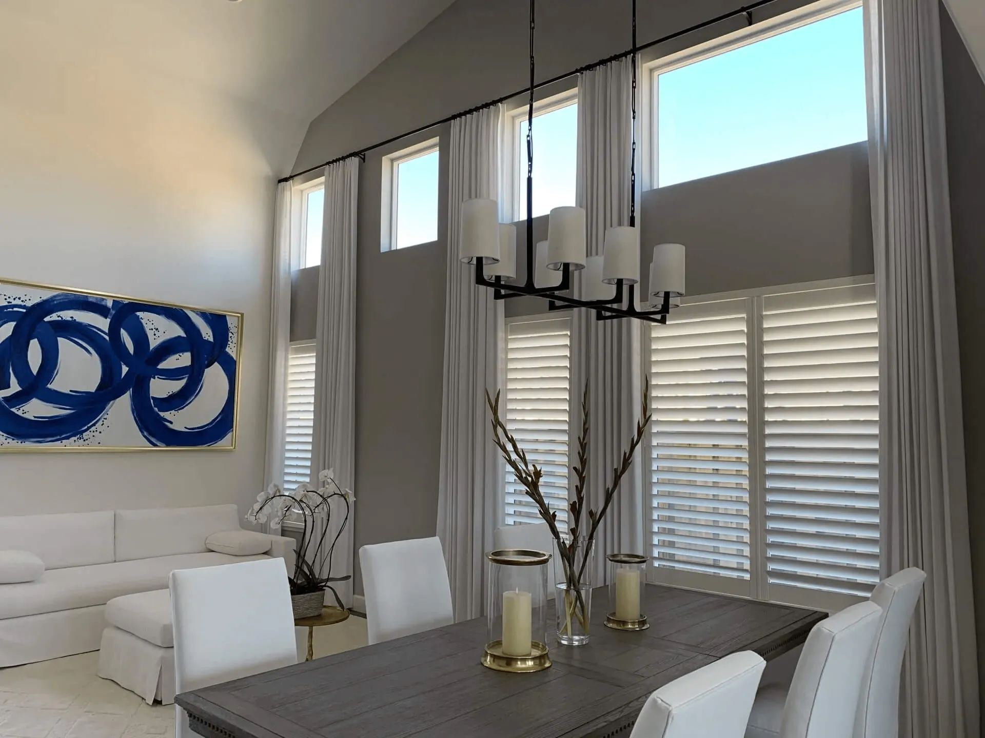 Modern dining room with tall windows, white drapes, and blinds.