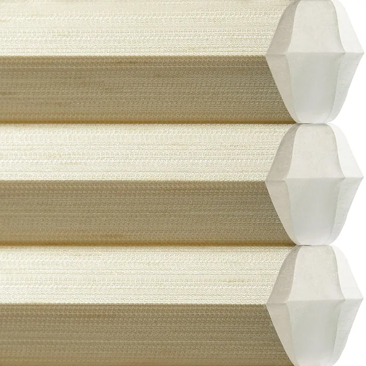 Beige cellular honeycomb shades, close-up.