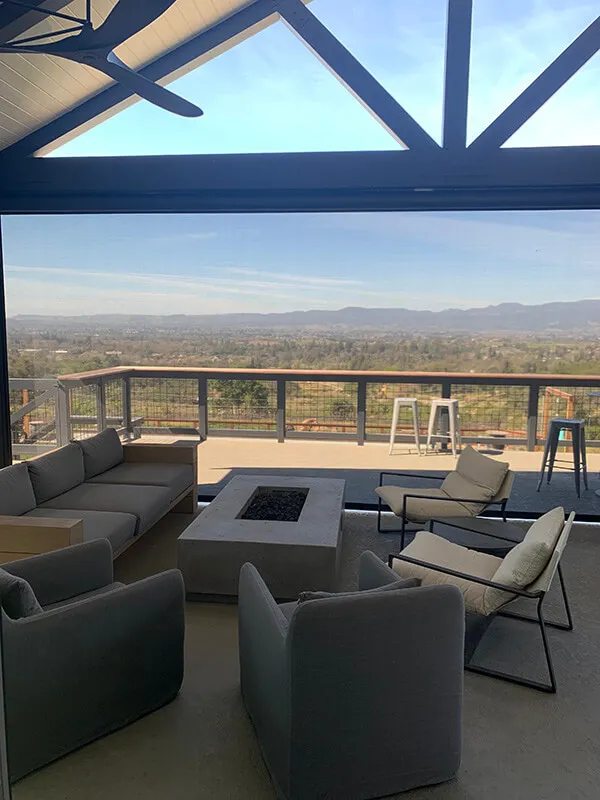 Outdoor seating with solar screens overlooking Santa Rosa landscape.