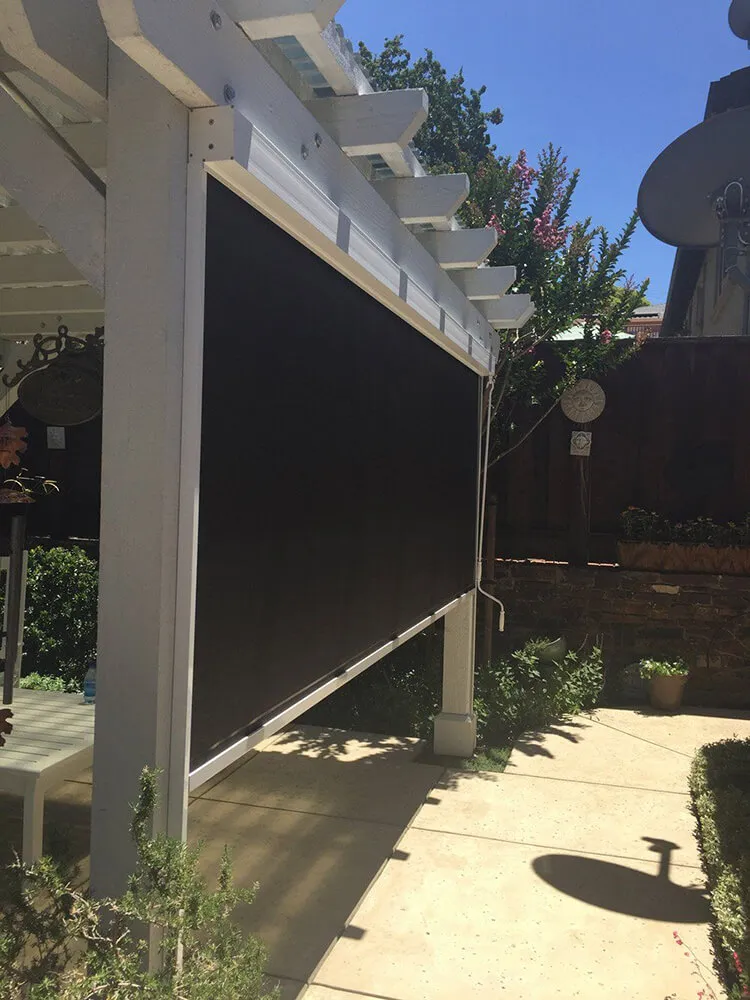 Outdoor solar screen under pergola