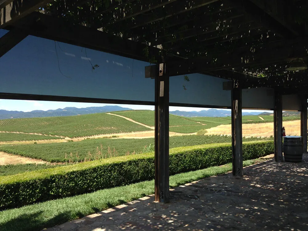 Patio with solar screens and vineyard view.