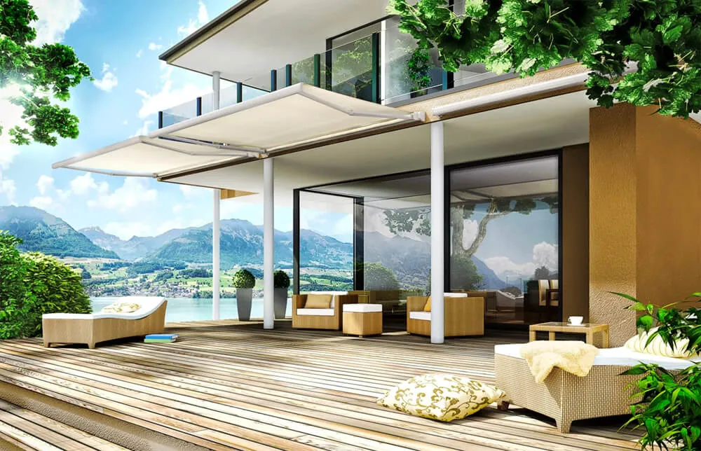 Modern patio with awnings and outdoor furniture, lake view.