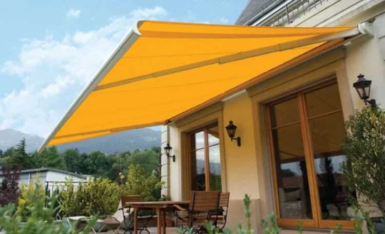 Orange awning over patio with outdoor furniture.