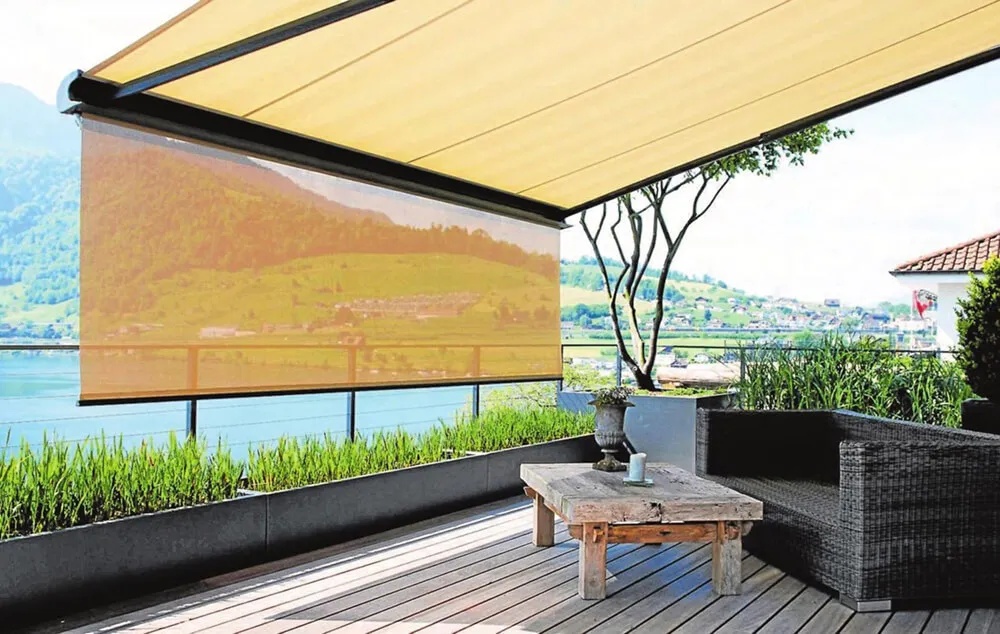 Patio with retractable awning, view of lake and hills.