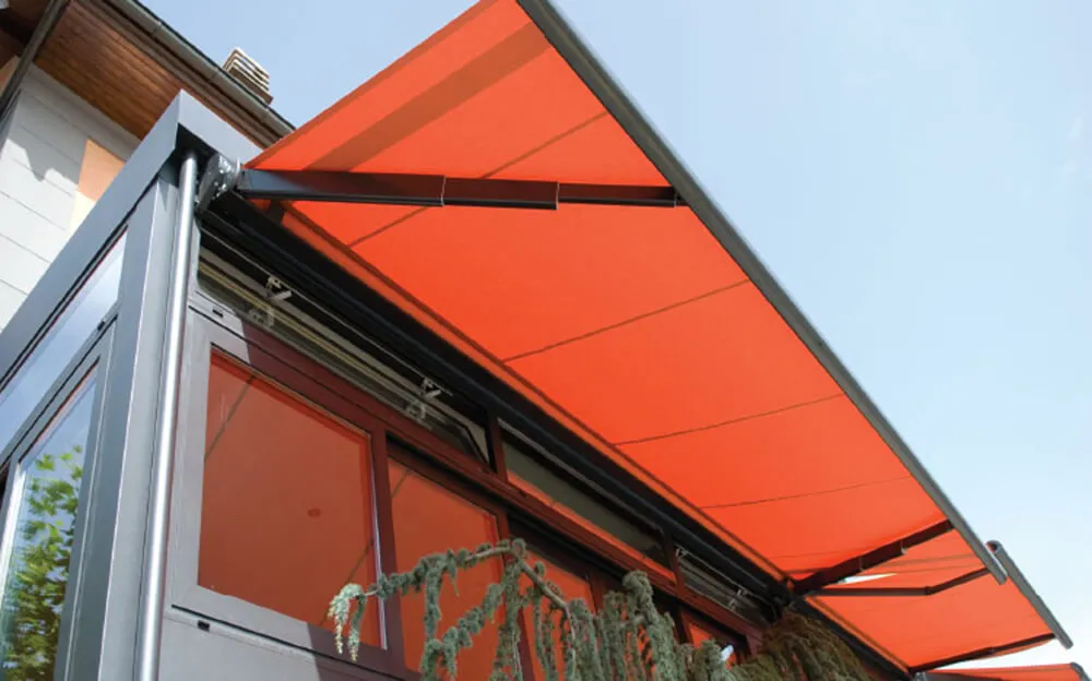 Orange awnings on modern house facade.