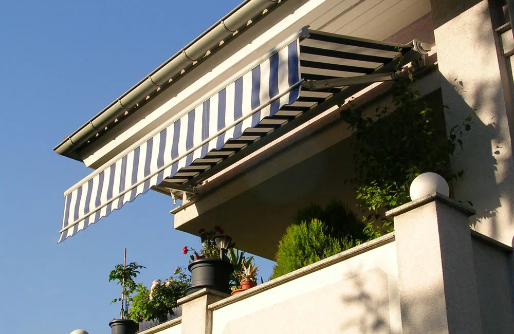 Striped retractable awning over balcony.