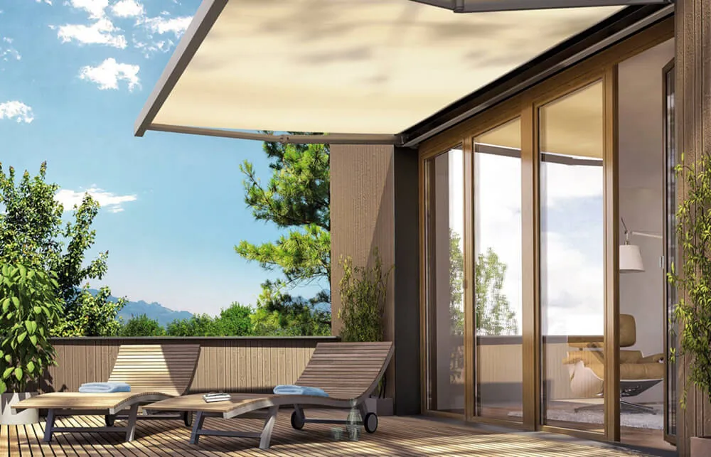 Patio with awning, lounge chairs, glass doors.