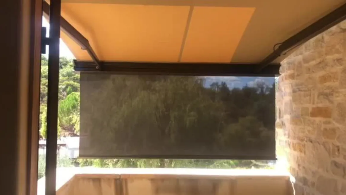 Retractable awning providing shade on balcony.