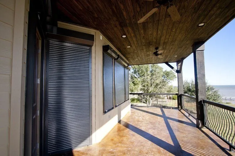 Rolling shutters on a wood-finished patio.