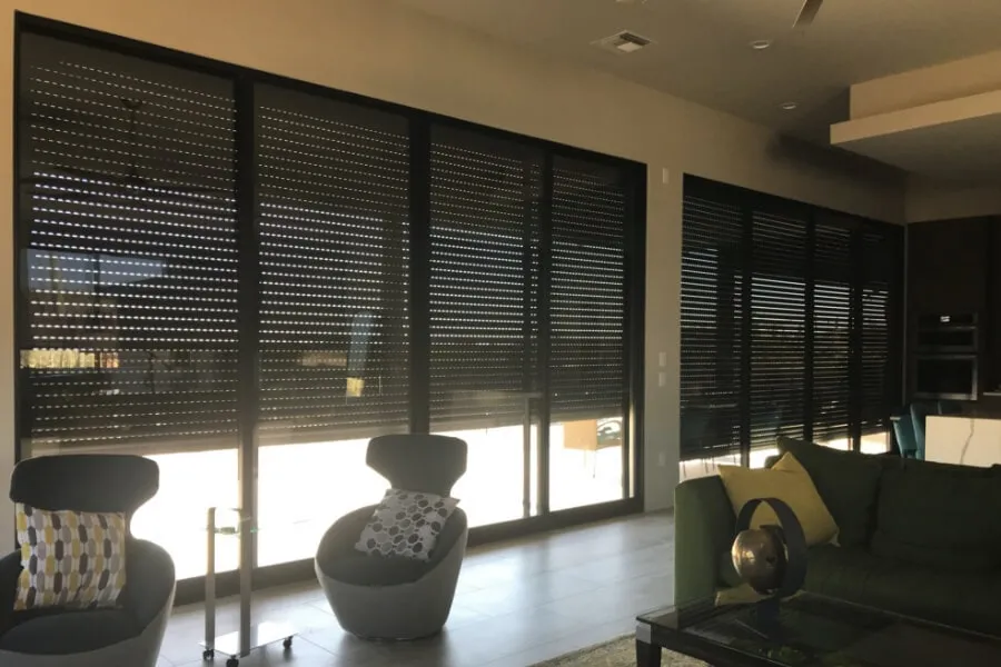 Living room with closed black rolling shutters.
