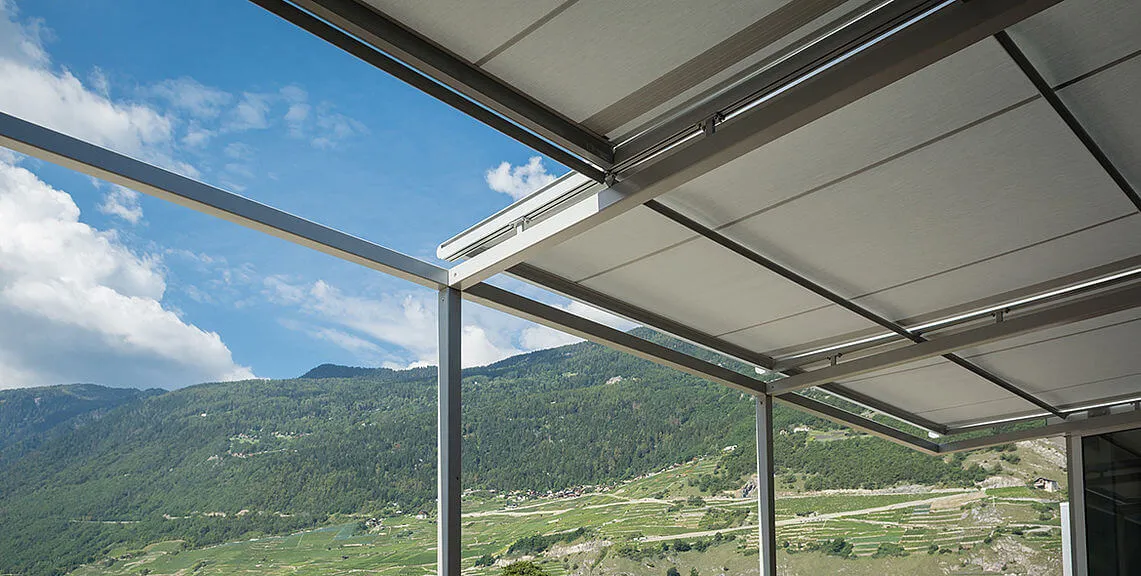 Retractable skylight cover with mountainous landscape.