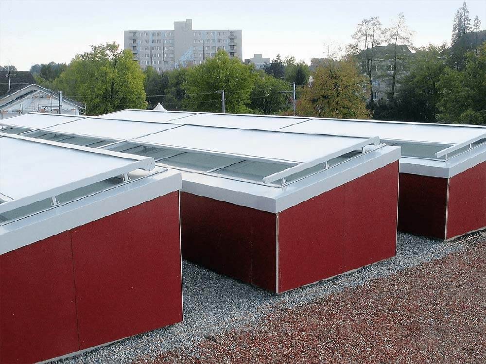 Skylight covers on red-roofed structure