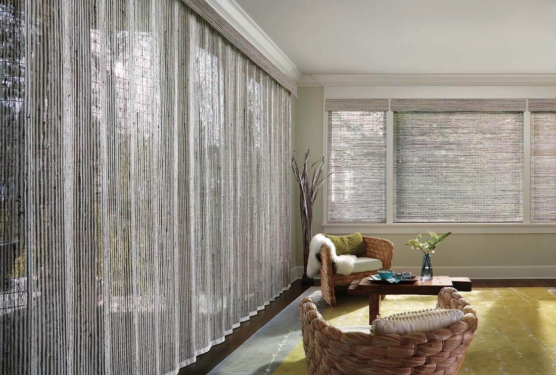 Living room with woven wood shades and sheer vertical blinds
