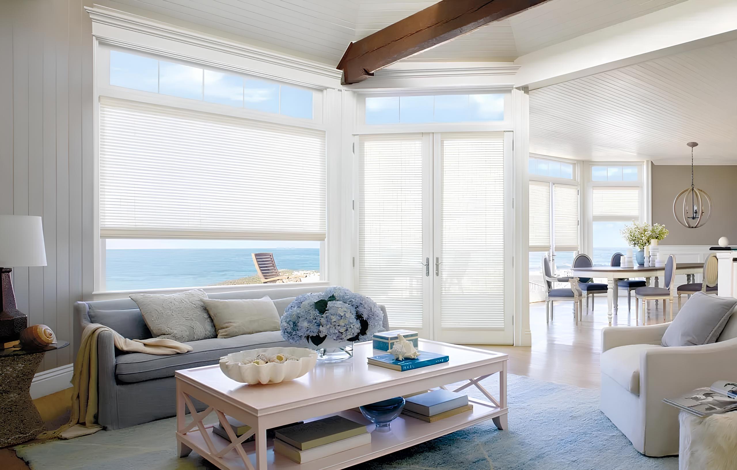 Living room with woven wood shades and ocean view.