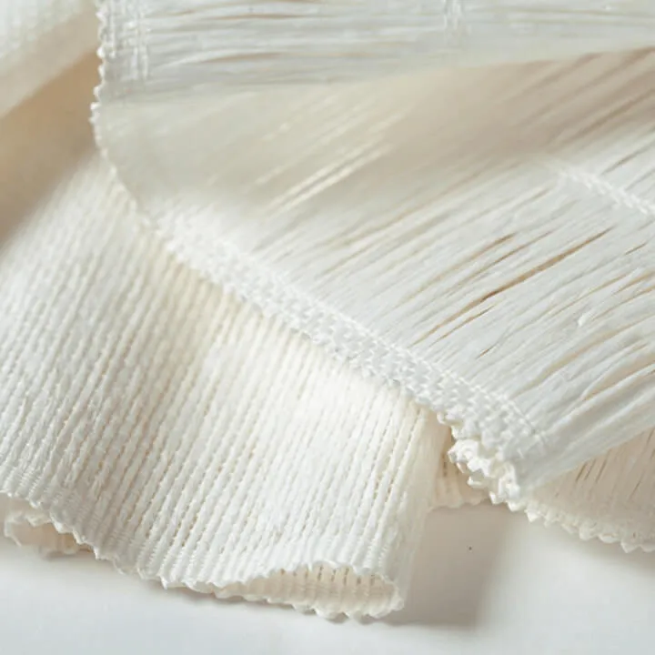 Close-up of textured woven wood shades in beige.