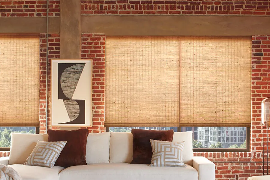 Living room with woven wood shades and modern art.