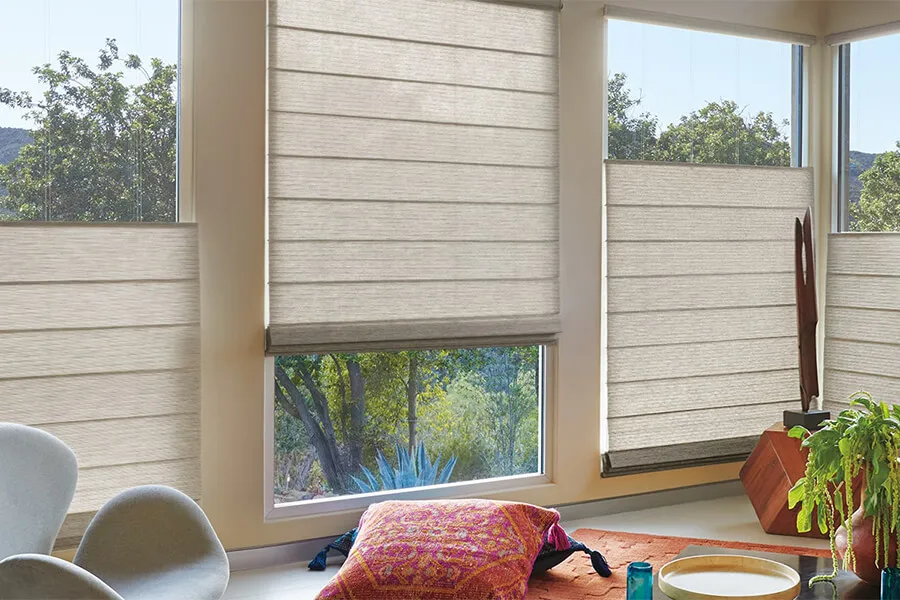 Living room with woven wood shades on large windows.