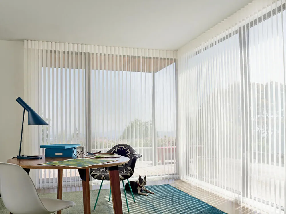 Modern room with vertical blinds on sliding glass doors.
